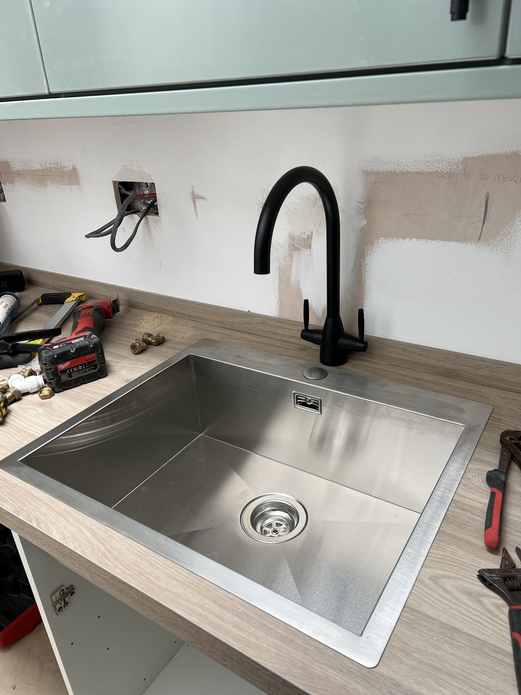Black mixer tap on a stainless steel sink
